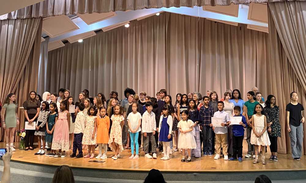 Group of children and adults on a stage